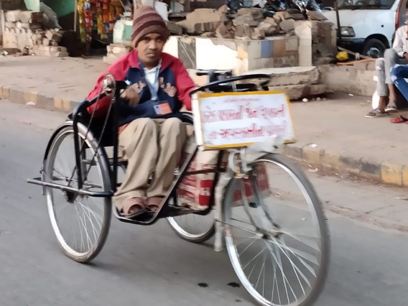 Sachin, Recipient of Tricycle from VOSAP, selling Incense Sticks, earning money! (Click for Photo)